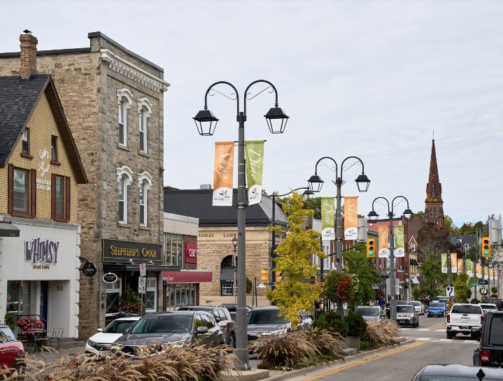 Historic Main Street in downtown Georgetown, Ontario, with shops and a church spire